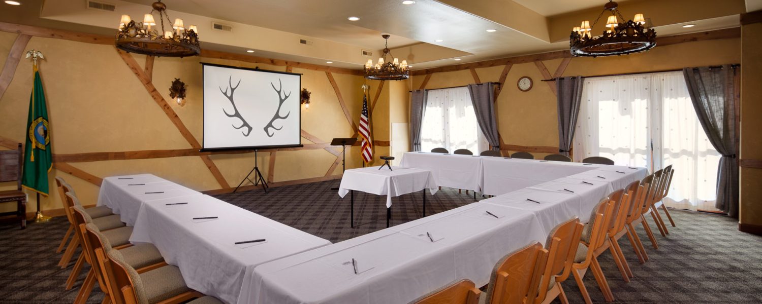 Conference room with rows of chairs and a u shaped table